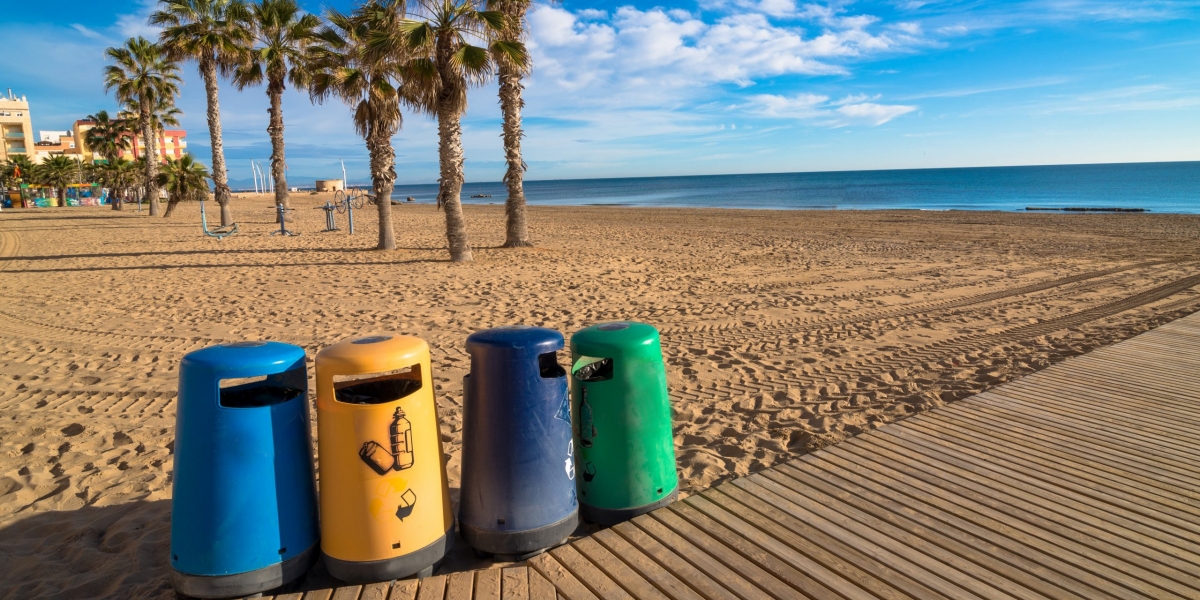 Selective recycling bins on a sunny resort beach